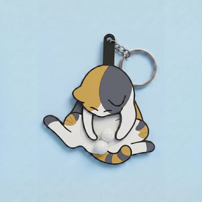 Anti-stress keychain in the shape of a cat and egg.