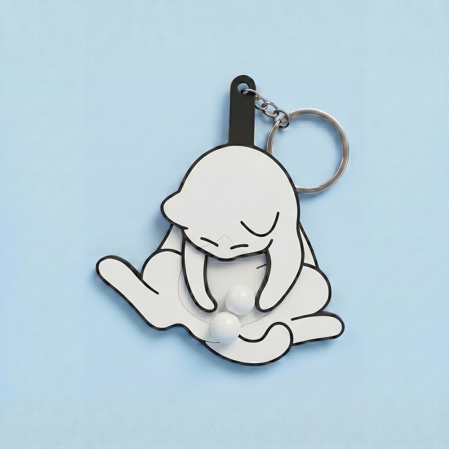 Anti-stress keychain in the shape of a cat and egg.