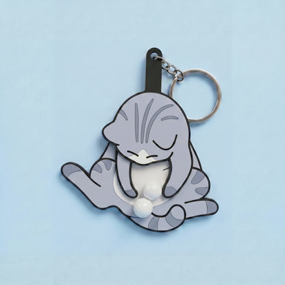 Anti-stress keychain in the shape of a cat and egg.