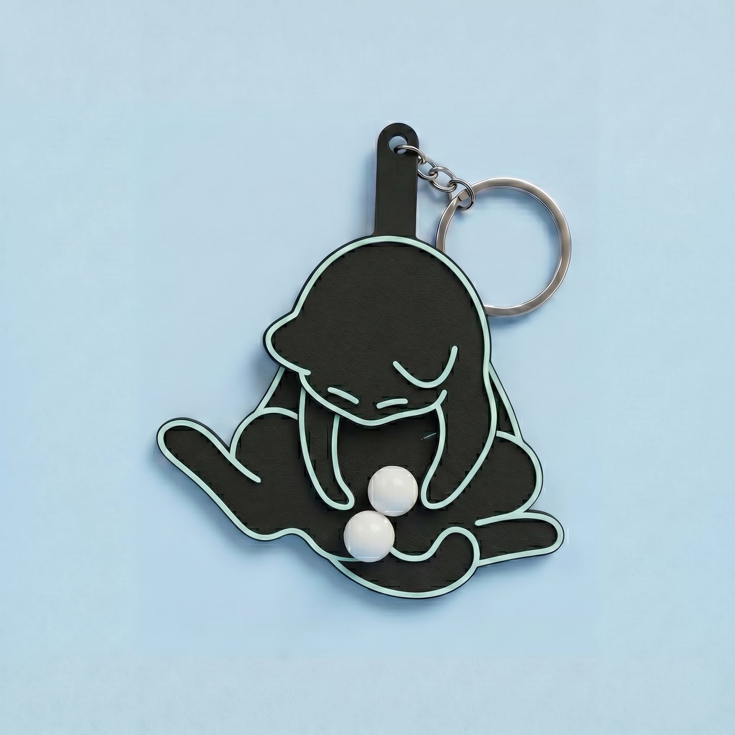 Anti-stress keychain in the shape of a cat and egg.