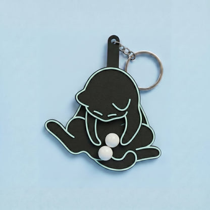 Anti-stress keychain in the shape of a cat and egg.